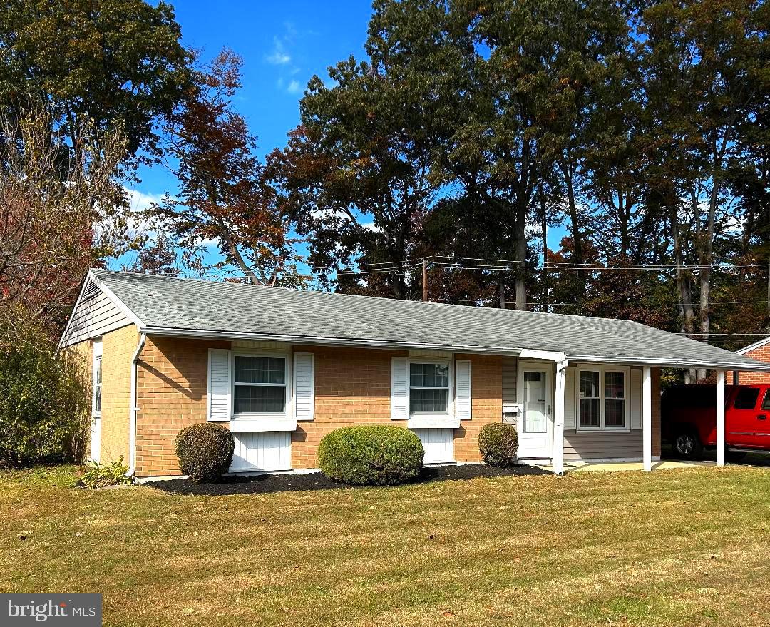 304 Barksdale Road Joppa, MD 21085 - Photo 5 of 24 a front view of a house with a garden and tree