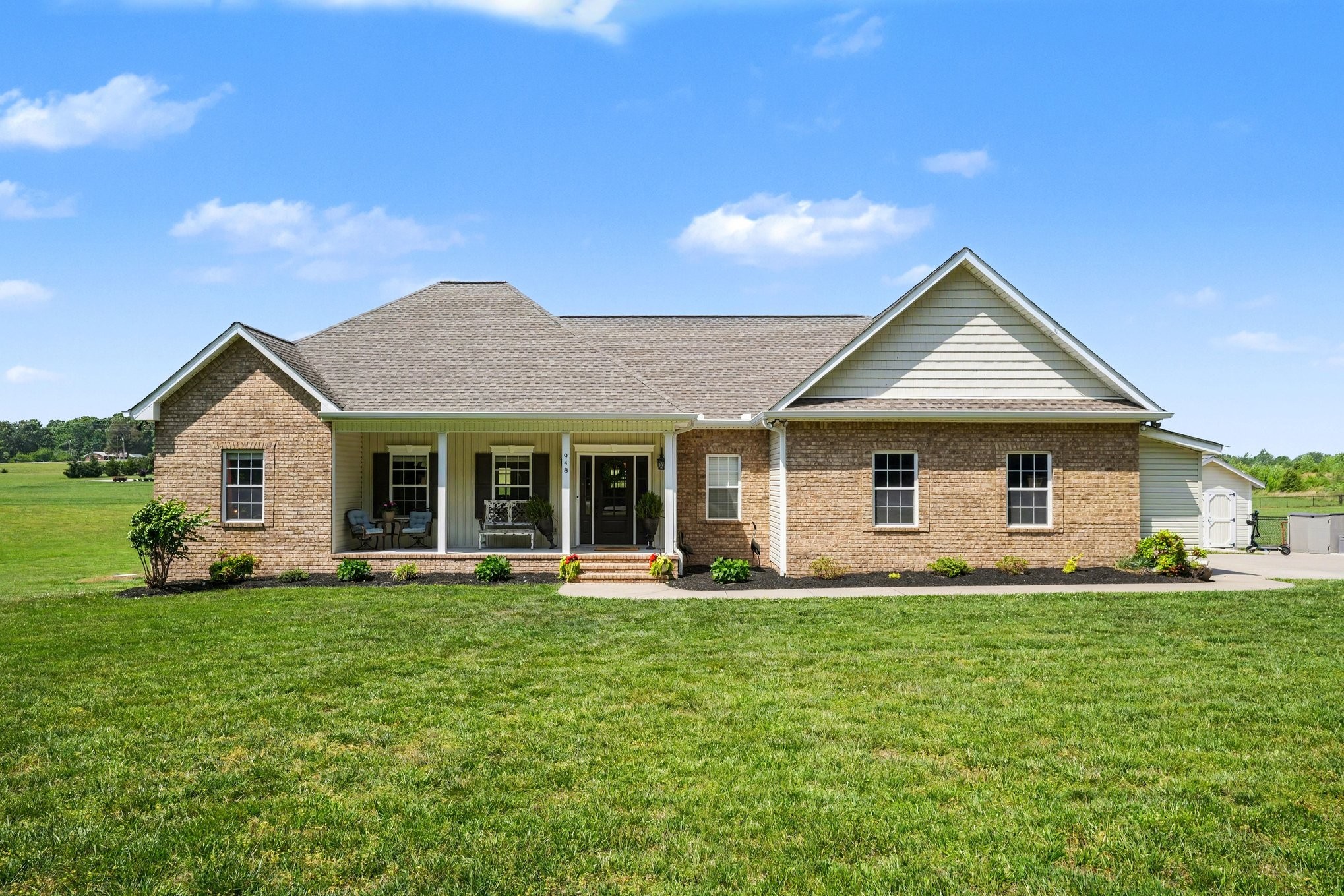 a front view of house with yard and green space