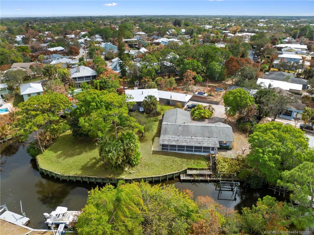 an aerial view of residential houses with outdoor space and swimming pool