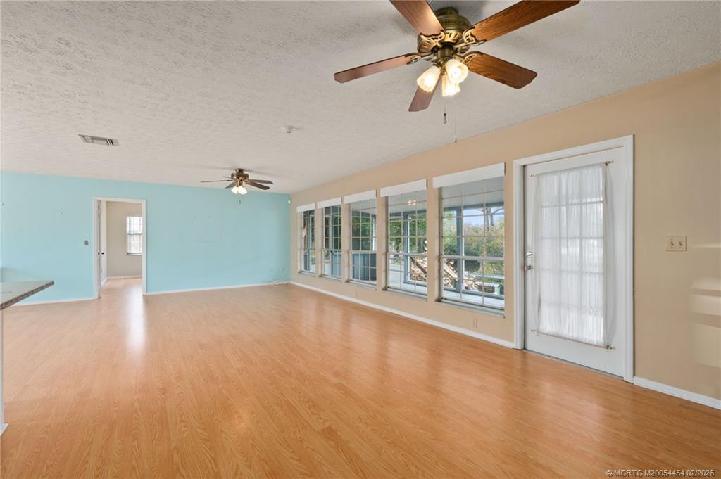 2493 Southwest Murphy Road Palm City, FL 34990 - Photo 12 of 50 a view of empty room with wooden floor and fan