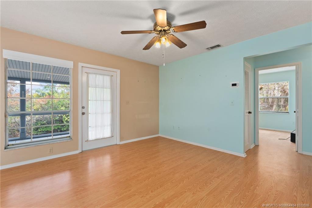 2493 Southwest Murphy Road Palm City, FL 34990 - Photo 13 of 50 wooden floor in an empty room with a window
