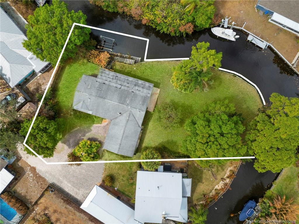 2493 Southwest Murphy Road Palm City, FL 34990 - Photo 2 of 50 an aerial view of a house with a yard basket ball court and outdoor seating
