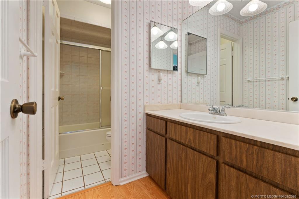 2493 Southwest Murphy Road Palm City, FL 34990 - Photo 23 of 50 a bathroom with a double vanity sink a mirror and a shower