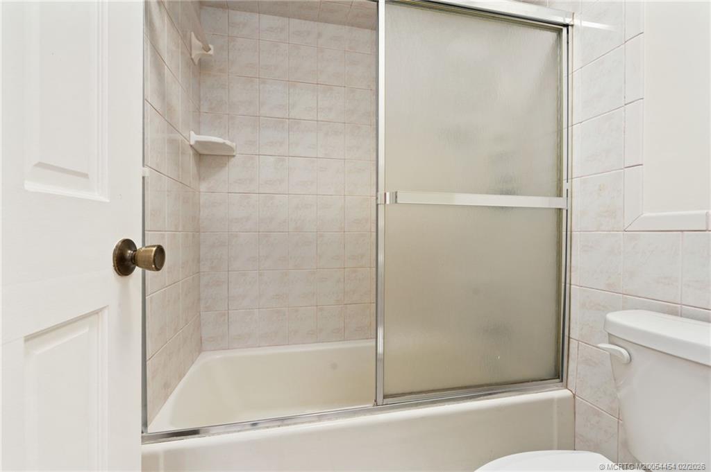 2493 Southwest Murphy Road Palm City, FL 34990 - Photo 24 of 50 a bathroom with a shower and a toilet