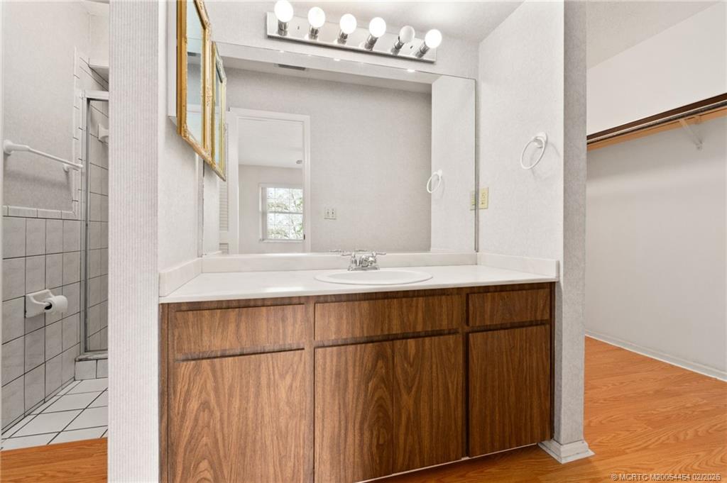 2493 Southwest Murphy Road Palm City, FL 34990 - Photo 27 of 50 a bathroom with a sink vanity and a mirror
