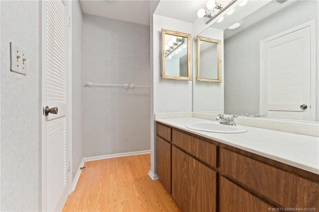 2493 Southwest Murphy Road Palm City, FL 34990 - Photo 28 of 50 a bathroom with a sink and a mirror
