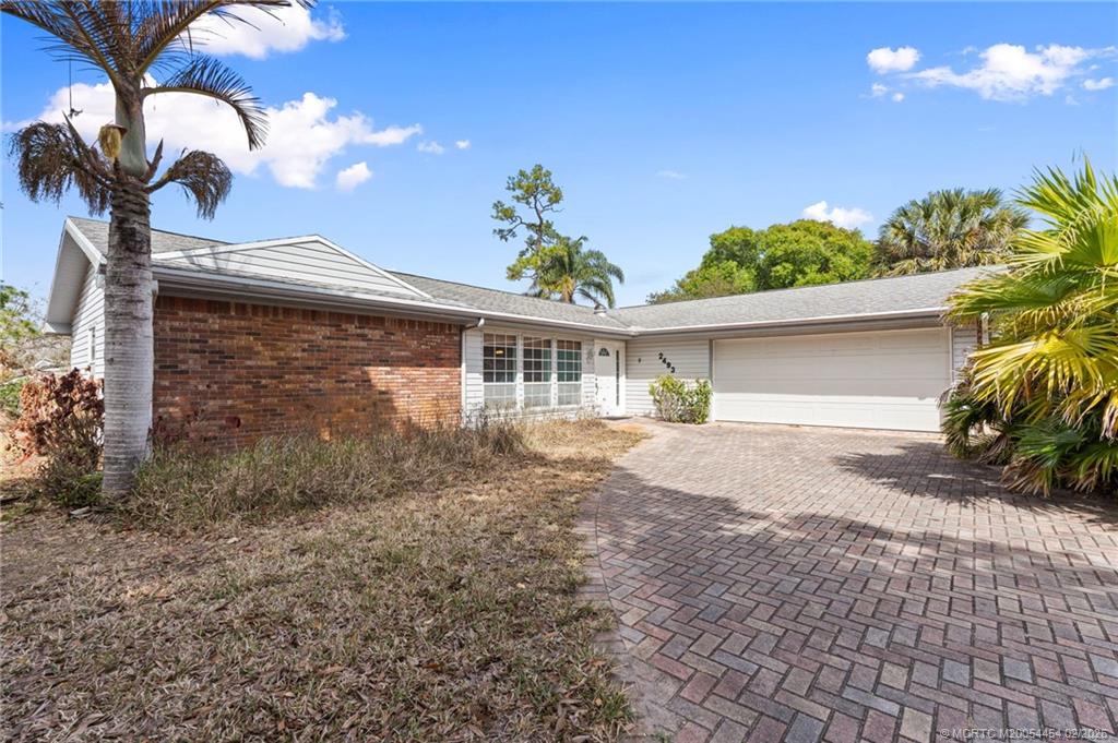 2493 Southwest Murphy Road Palm City, FL 34990 - Photo 5 of 50 a front view of a house with garden