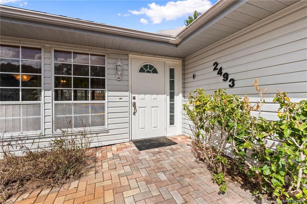 2493 Southwest Murphy Road Palm City, FL 34990 - Photo 6 of 50 a view of a entryway door of the house
