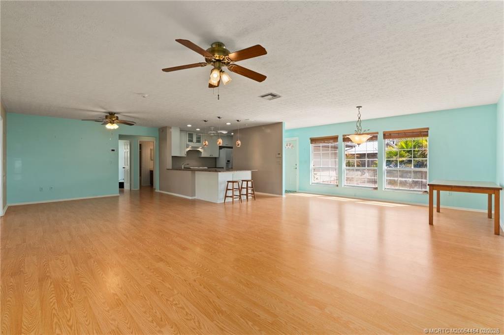 2493 Southwest Murphy Road Palm City, FL 34990 - Photo 9 of 50 a view of an empty room with a window and wooden floor