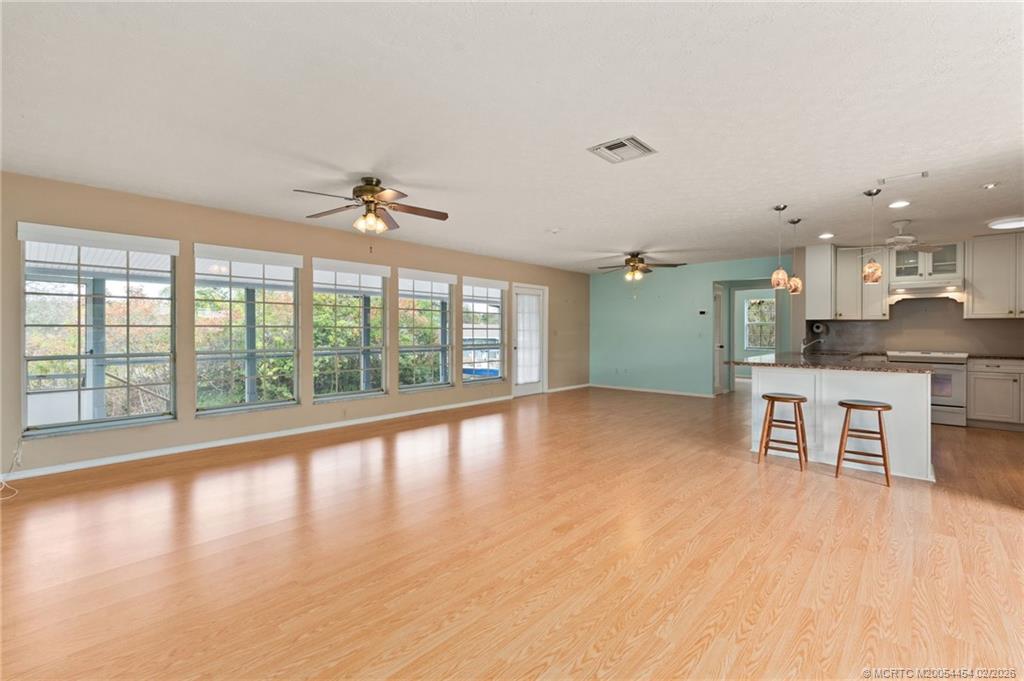 2493 Southwest Murphy Road Palm City, FL 34990 - Photo 10 of 50 a view of an empty room with a window and wooden floor