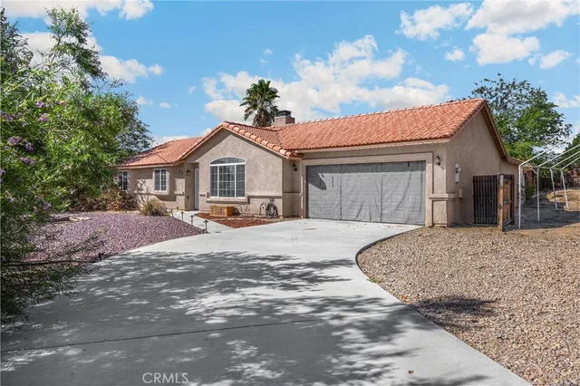 a front view of a house with a garden and yard