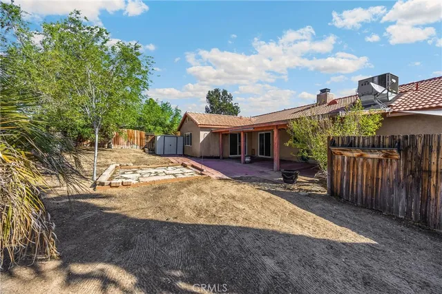 a view of a patio with table and chairs with wooden floor and fence