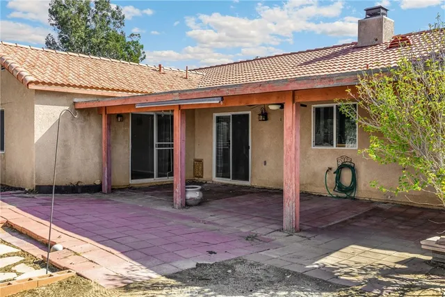 a view of a backyard with wooden floor and fence