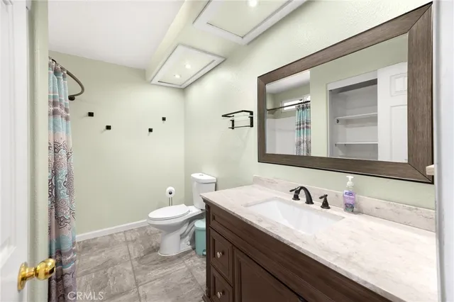 a bathroom with a sink toilet and mirror