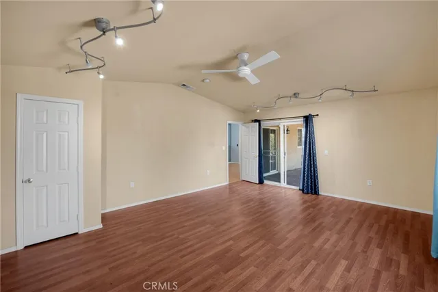 a view of a kitchen with a flat screen tv and refrigerator