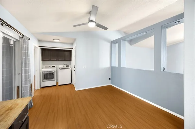 a living room with a fireplace and wooden floor