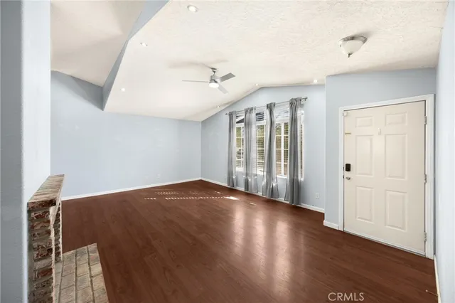 a large kitchen with stainless steel appliances granite countertop a refrigerator a stove top oven a sink and dishwasher