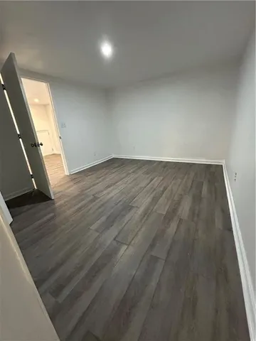 en empty room with wooden floor