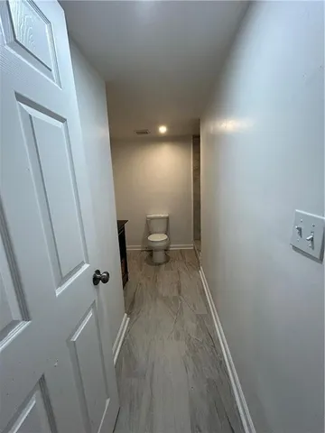 a view of a room with wooden floor