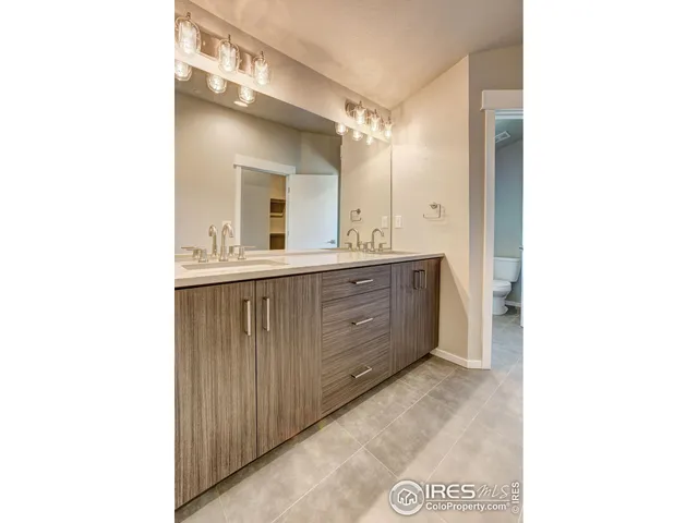 a bathroom with a double vanity sink and mirror