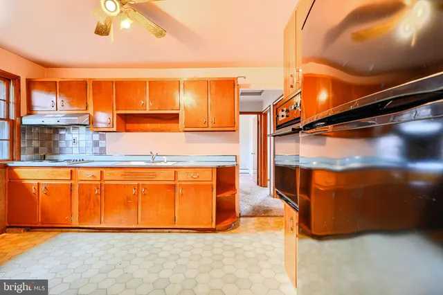 a view of a kitchen with a sink and cabinets