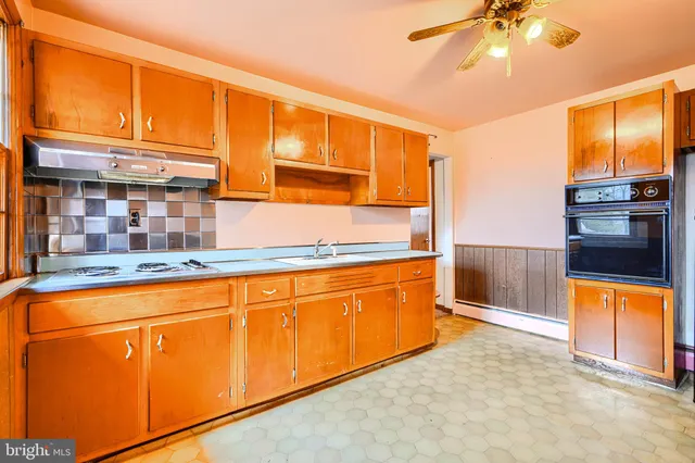 a view of a kitchen with a sink and cabinets
