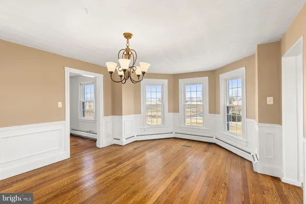 a view of an room with wooden floor and windows