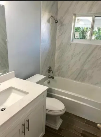 a bathroom with a toilet a sink and a bathtub