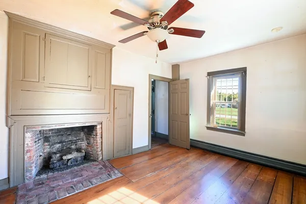 a kitchen with stainless steel appliances granite countertop a refrigerator a stove and a wooden floor