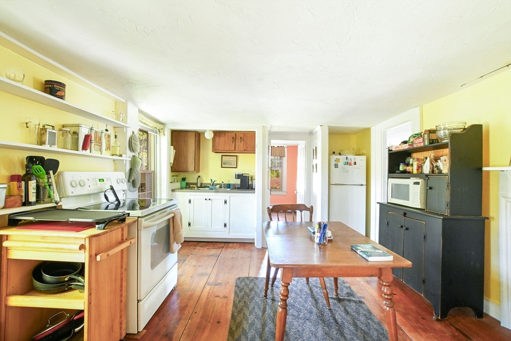 363 Main Street Acushnet, MA 02743 - Photo 23 of 35 a kitchen with stainless steel appliances granite countertop a refrigerator a stove and a wooden floor