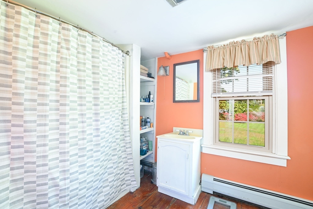 363 Main Street Acushnet, MA 02743 - Photo 26 of 35 a bathroom with a toilet a sink and a shower curtain