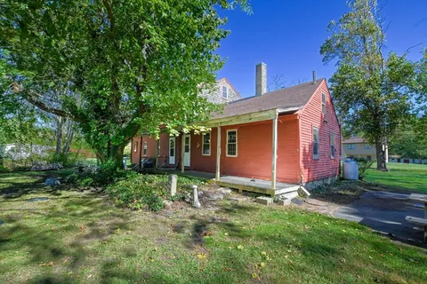 a view of a backyard with large trees