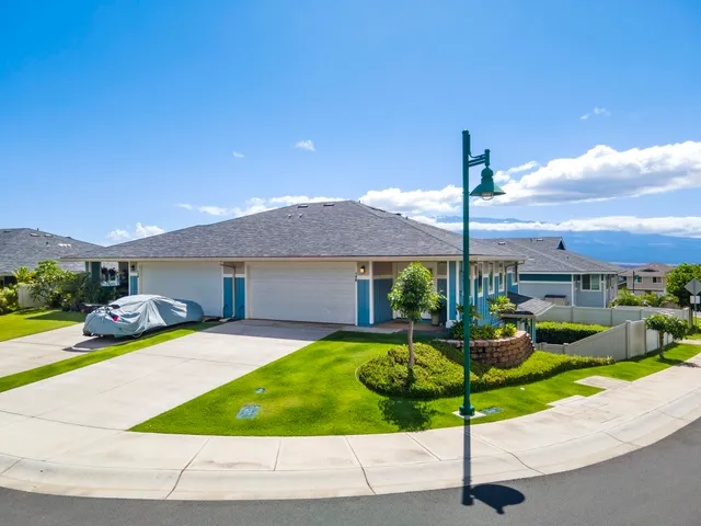 a front view of a house with garden and patio