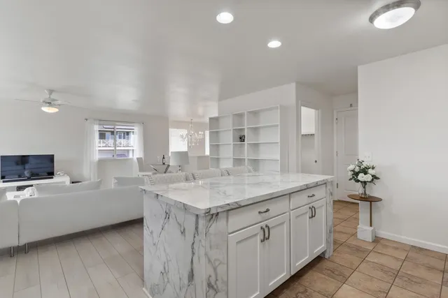 a view of a house with brick walls and a yard with a large tree