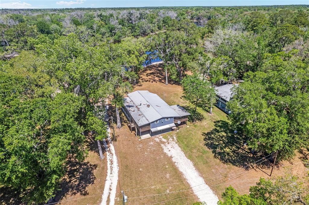 7870 Southwest 25th Place Bell, FL 32619 - Photo 5 of 99 an aerial view of a house with a yard basket ball court and outdoor seating