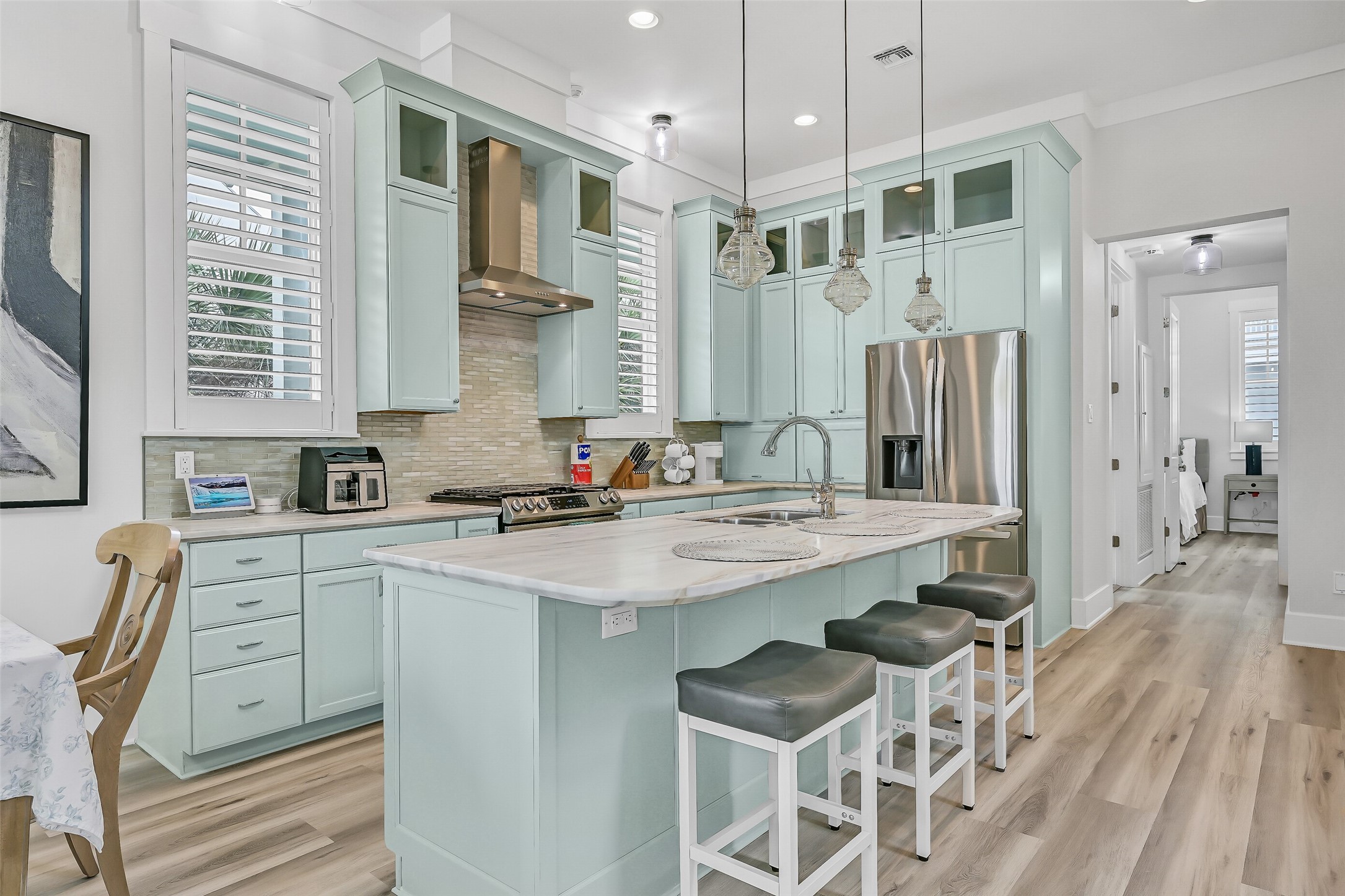 817 Positano Road Galveston, TX 77550 - Photo 15 of 50 Beautiful custom cabinetry, generous prep space, and premium finishes make this kitchen the heart of the home. Recent upgrades, including enhanced ventilation above the stove and refreshed finishes, elevate both functionality and design.
