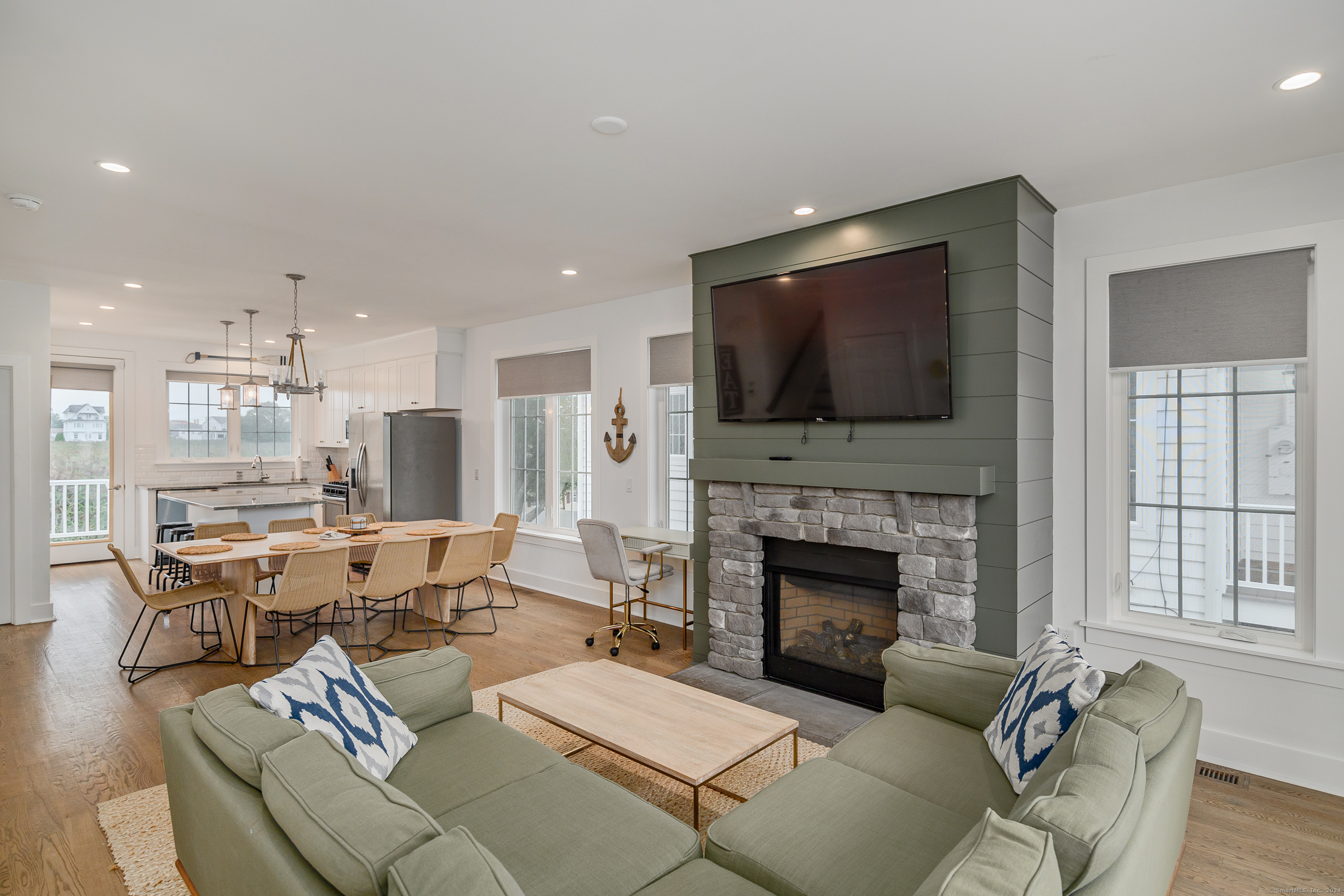 1033 Reef Road Fairfield, CT 06824 - Photo 12 of 32 a living room with furniture fireplace and flat screen tv