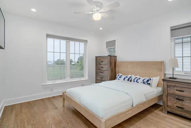 a bedroom with a large bed and a chandelier