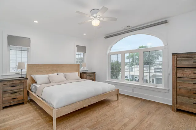 a bedroom with a large bed and a large window