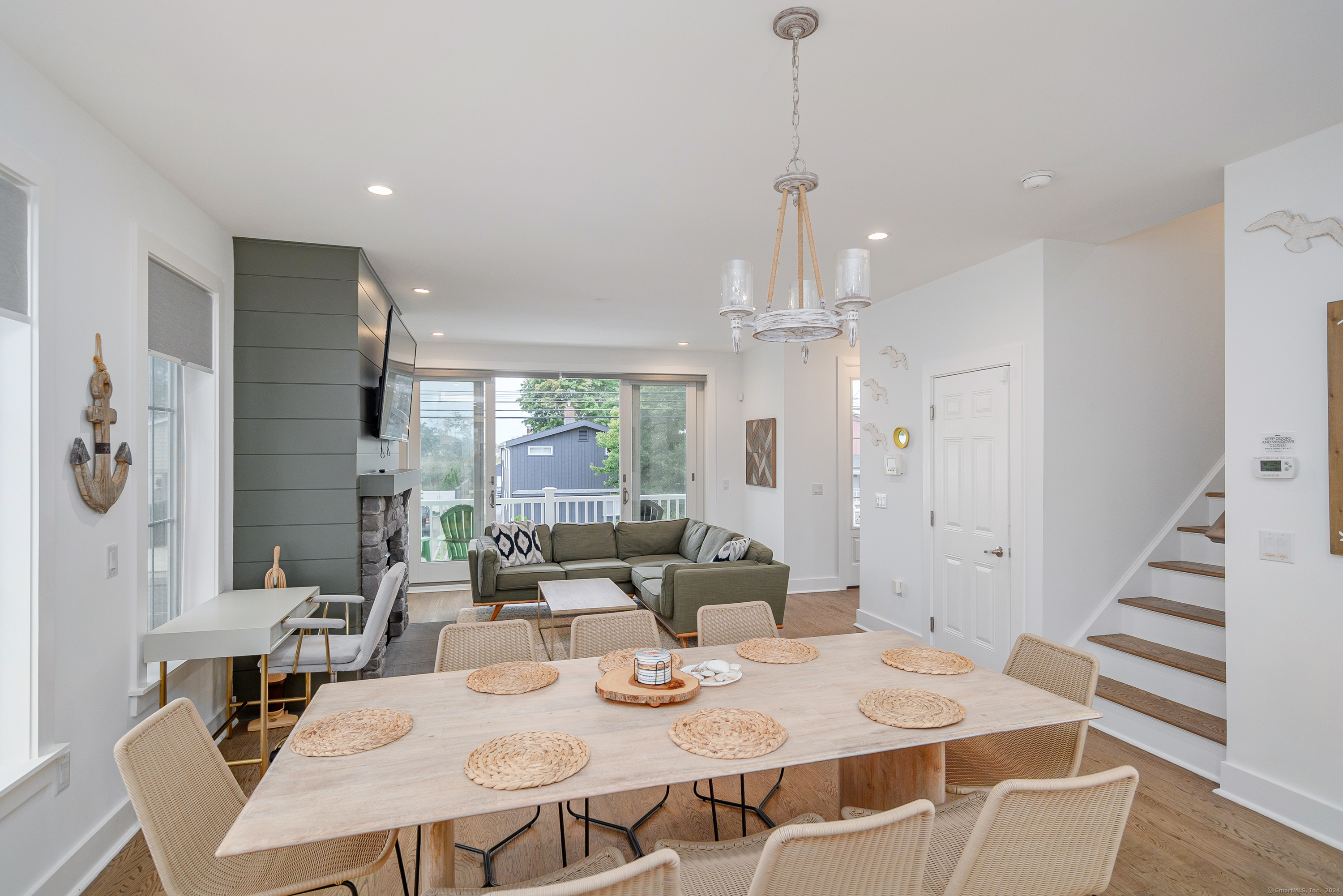 1033 Reef Road Fairfield, CT 06824 - Photo 18 of 32 a view of a dining room with furniture window and wooden floor