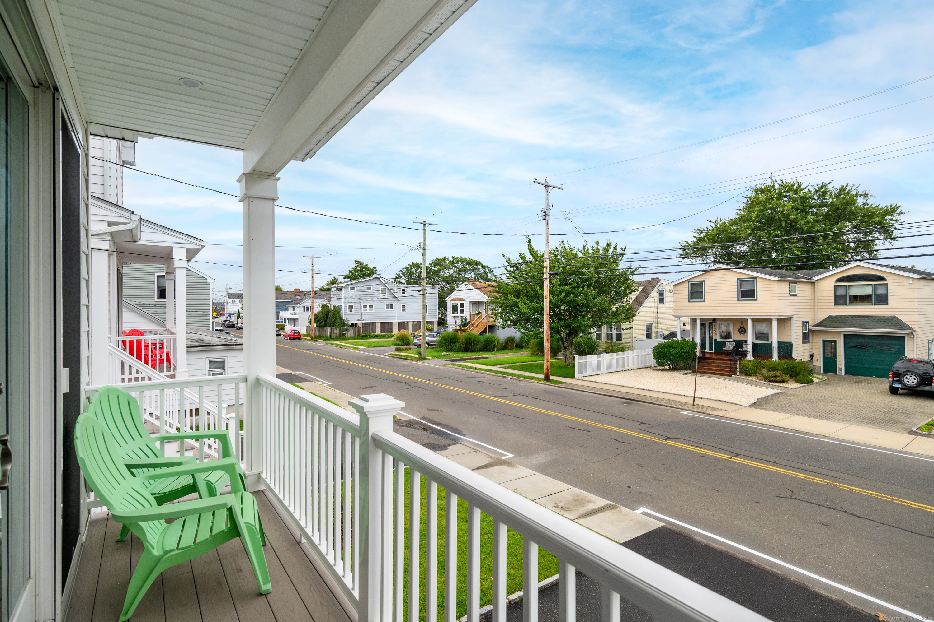 1033 Reef Road Fairfield, CT 06824 - Photo 2 of 32 a balcony with table and chairs