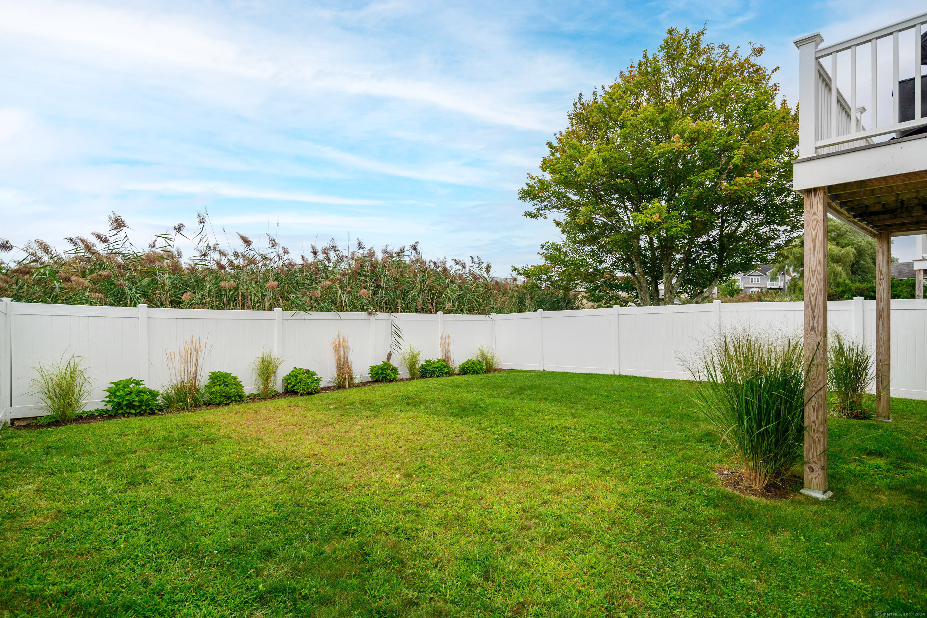 1033 Reef Road Fairfield, CT 06824 - Photo 28 of 32 a backyard of a house with lots of green space