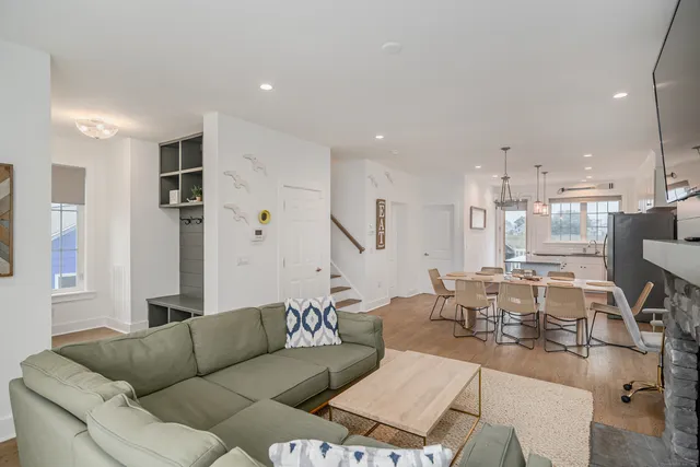 a living room with furniture kitchen view and a refrigerator
