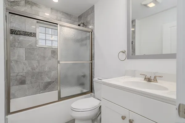 a bathroom with a sink toilet and shower