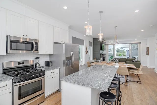 a kitchen with stainless steel appliances granite countertop a stove and a refrigerator