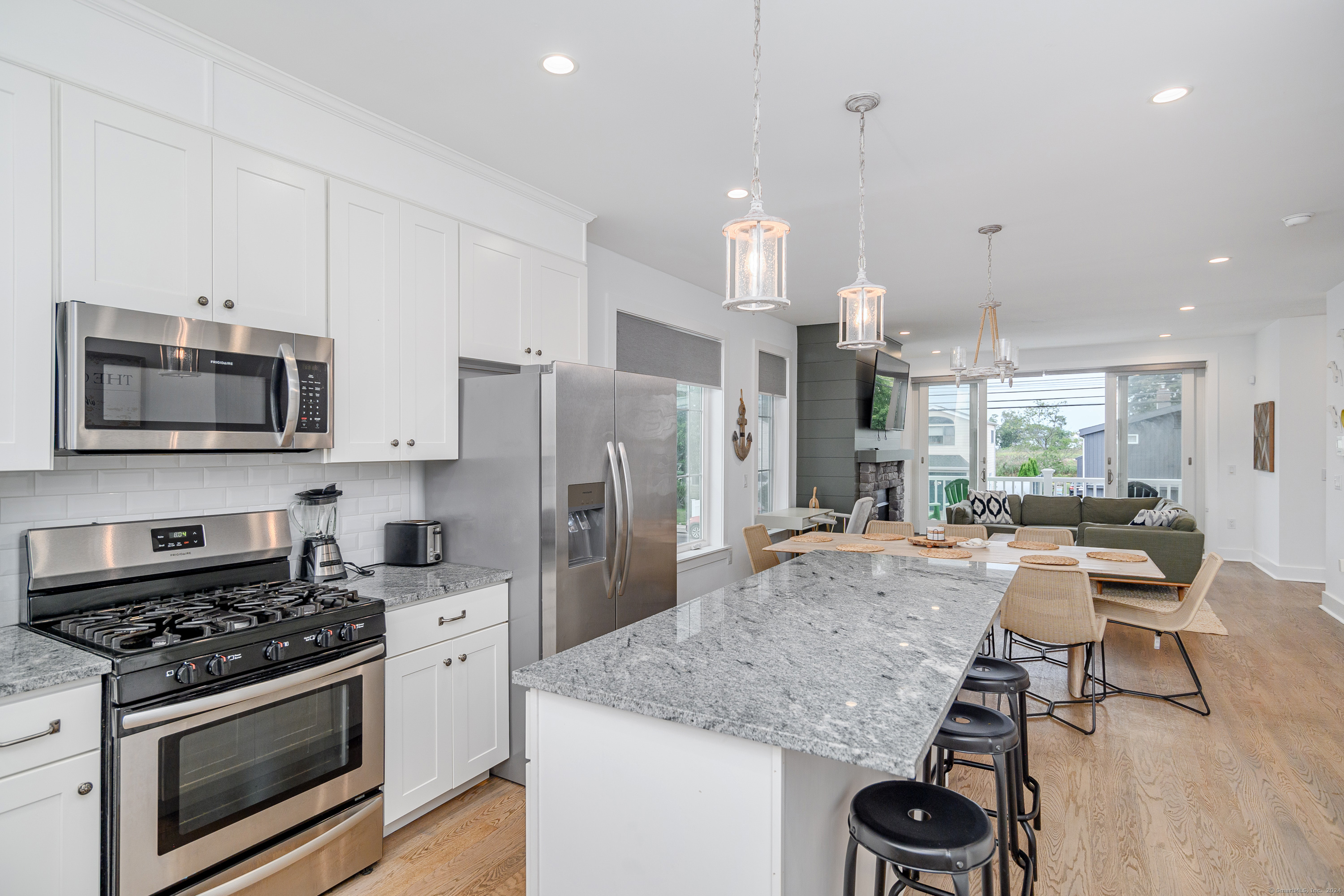 1033 Reef Road Fairfield, CT 06824 - Photo 9 of 32 a kitchen with stainless steel appliances granite countertop a stove and a refrigerator
