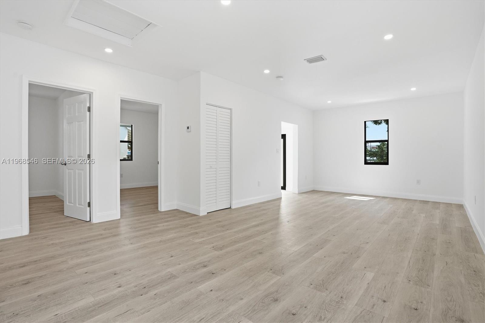 4237 Southwest 7th Street Miami, FL 33134 - Photo 4 of 31 an empty room with wooden floor and bathroom