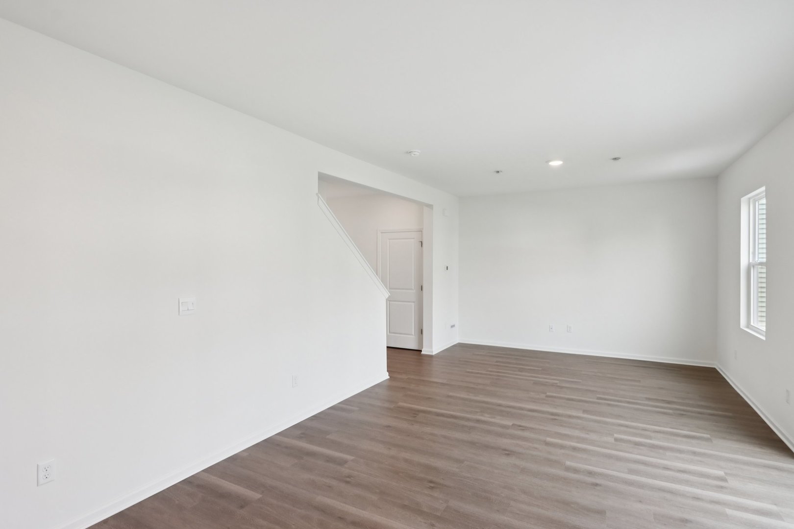 1271 Acadia Circle Pingree Grove, IL 60140 - Photo 8 of 36 a view of an empty room with wooden floor and a window