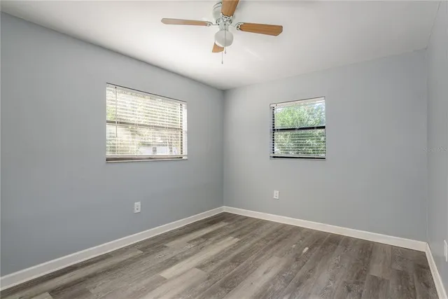 a view of an empty room with wooden floor
