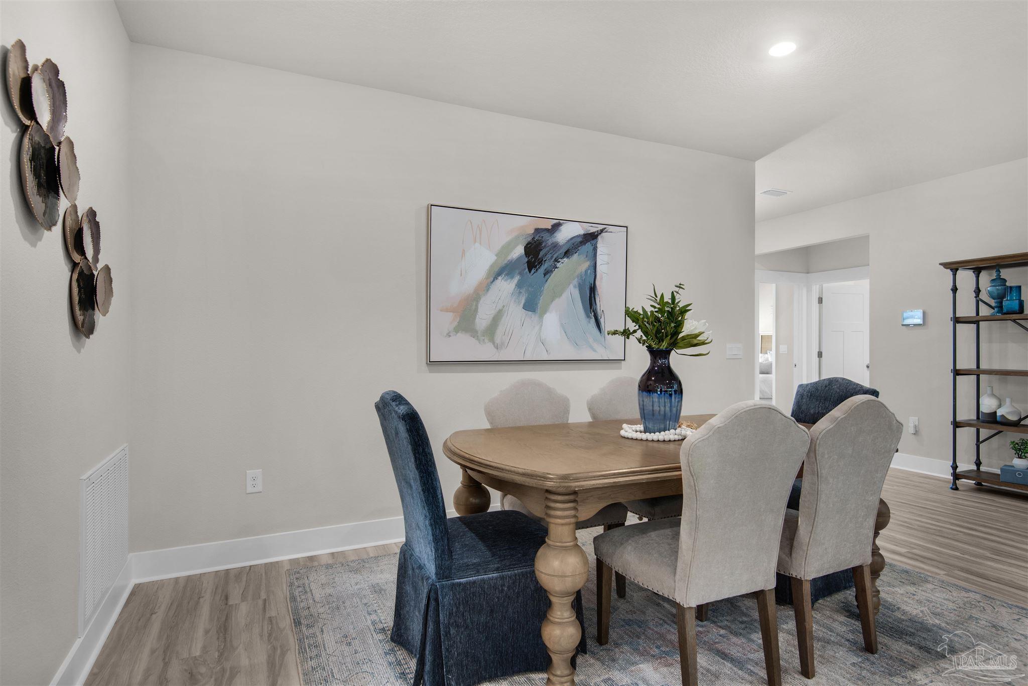3269 Water Birch Road Cantonment, FL 32533 - Photo 21 of 45 a view of a dining room with furniture and wooden floor